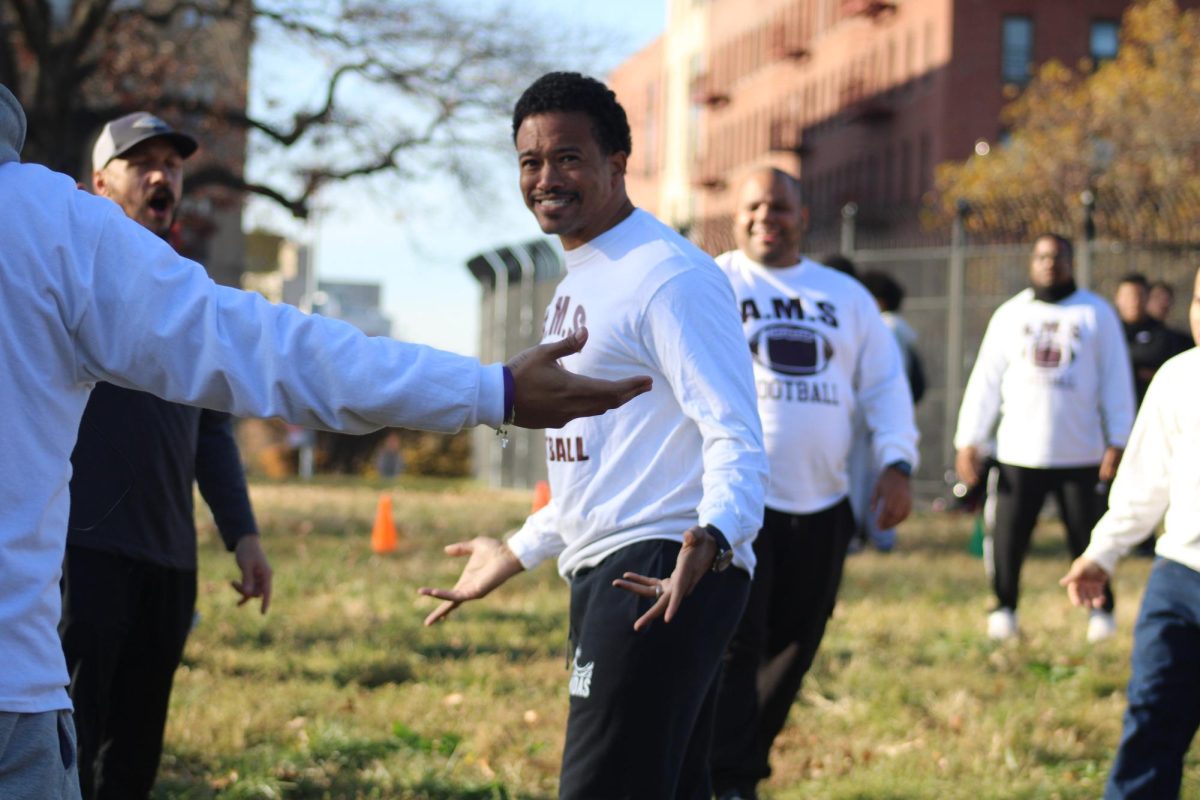 Mr. Scott exchanges smiles with his teammates.