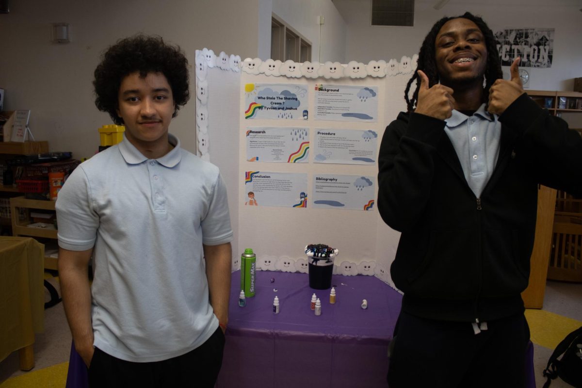 Seniors Joshua Ayala and Tyviion Anthony display their project on how rain works. 