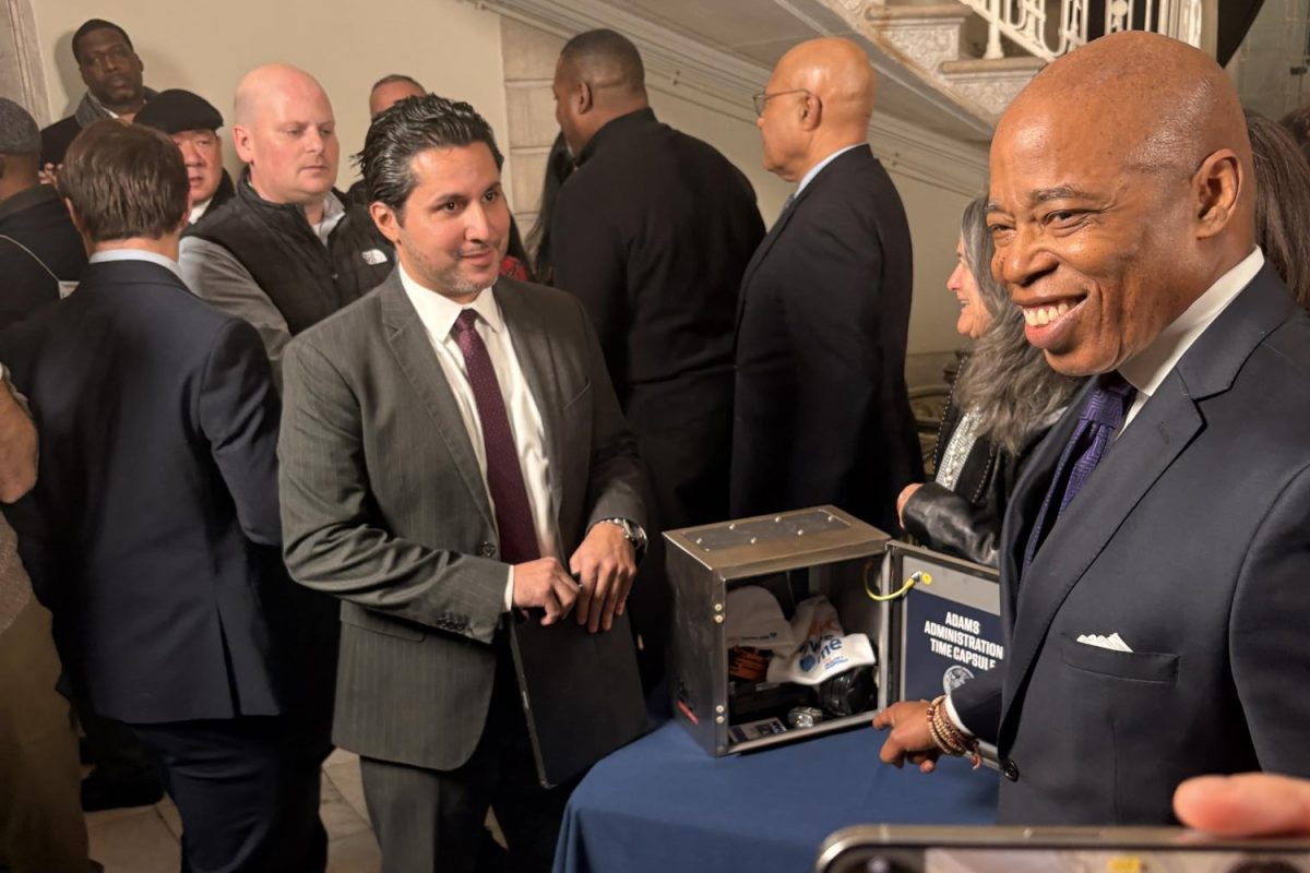 Mayor Adams next to the time capsule