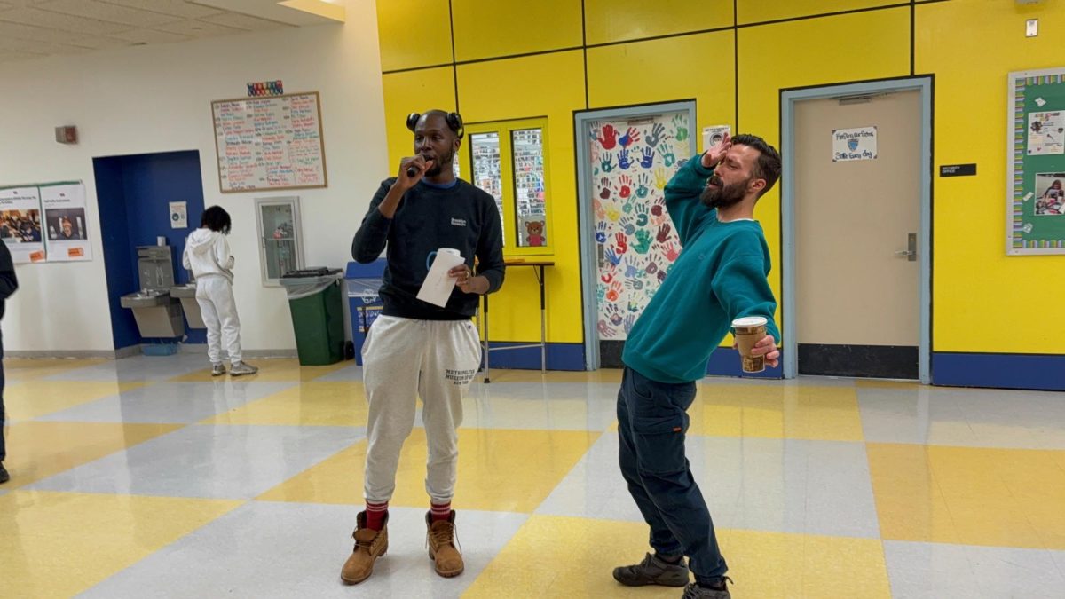 Mr. Baker and Mr. McCausland sing together. 