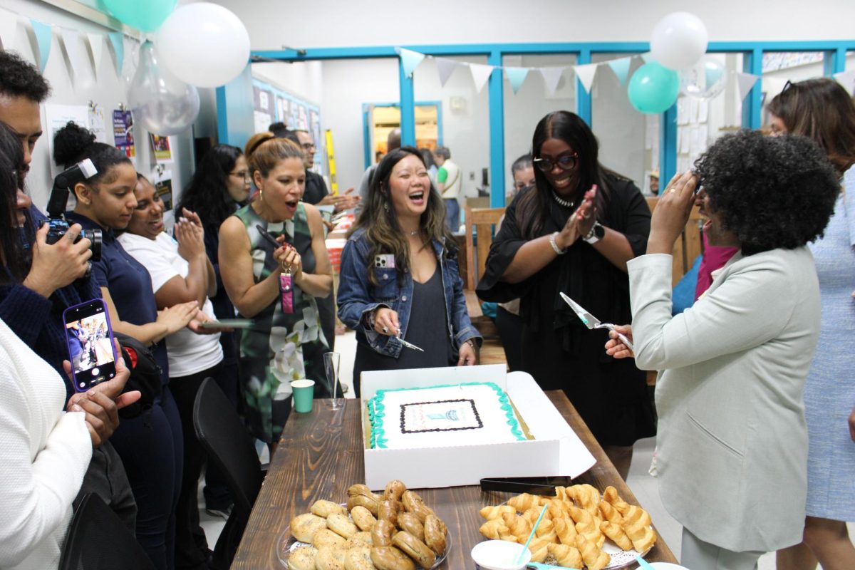Principal Chung, special guests, and the AMS community gather in the new Teacher Center to cut the cake.